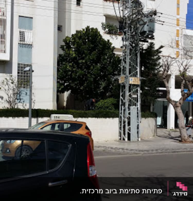 Street scene with cars and a building, no visible plumber elements.